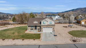 View of front facade with a garage and a mountain view