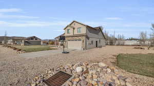 View of front of property with a garage and a front yard