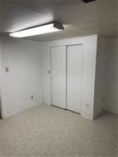Unfurnished bedroom with light tile floors and a closet