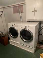 Washroom featuring washing machine and clothes dryer