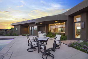 Patio terrace at dusk featuring grilling area