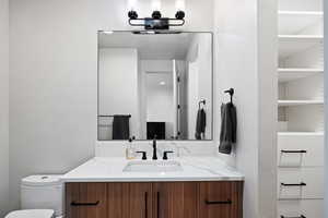 Bathroom with oversized vanity and toilet