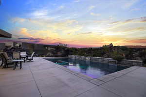 Pool at dusk with a patio