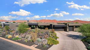 View of front of house with a garage and a mountain view