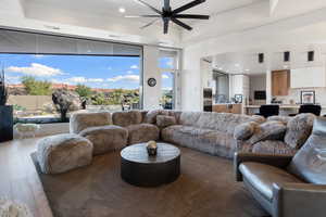 Living room featuring dark hardwood / wood-style floors and ceiling fan