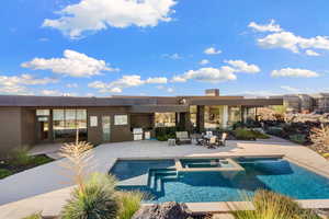 View of swimming pool with a patio area, an in ground hot tub, and area for grilling