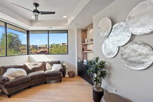 Living room featuring a healthy amount of sunlight, light wood-type flooring, and ceiling fan