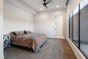 Carpeted bedroom featuring ceiling fan and access to exterior