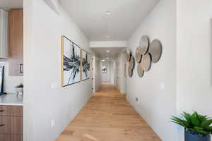 Hallway with light hardwood / wood-style floors