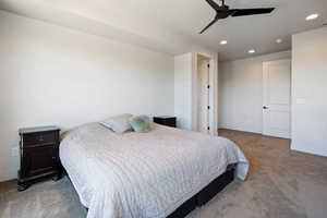 Carpeted bedroom with ceiling fan