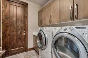 Laundry room with cabinets and washing machine and dryer