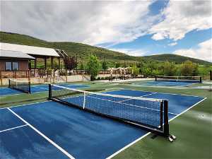 View of tennis court with a mountain view