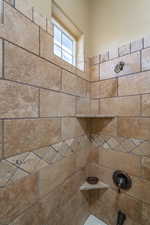 Interior details featuring tiled shower / bath combo