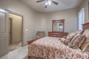 Carpeted bedroom with ceiling fan