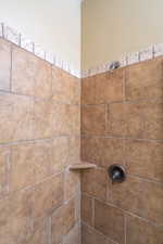 Room details featuring tiled shower