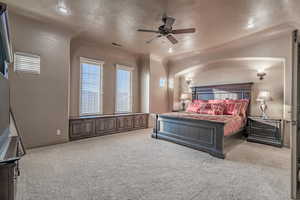 Carpeted bedroom featuring ceiling fan