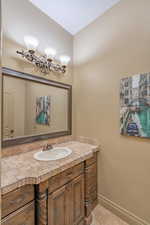 Bathroom featuring tile floors and vanity with extensive cabinet space