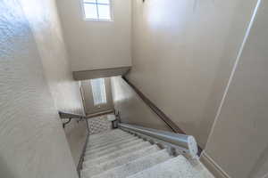 Stairs featuring carpet flooring and stair / chair lift