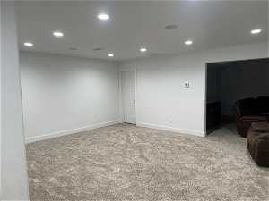 Play room in basement with light carpet