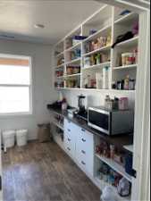 View of pantry with custom built shelving and drawers