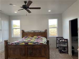 Carpeted Master bedroom featuring multiple windows and ceiling fan