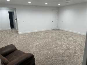 Basement play room with light carpet