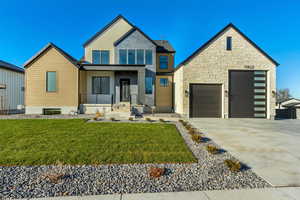 Modern home featuring a front yard and a garage