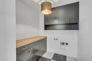 Laundry area featuring cabinets, tile floors, electric dryer hookup, and hookup for a washing machine