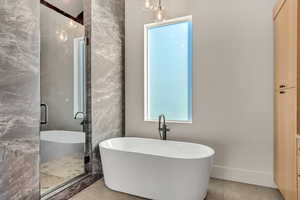 Bathroom featuring independent shower and bath and tile floors