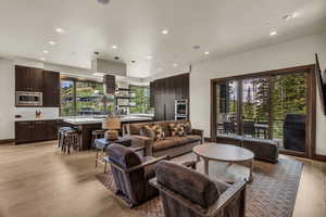 Living room featuring plenty of natural light and light hardwood / wood-style flooring