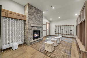 Living room with a stone fireplace and high vaulted ceiling