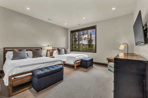 Bedroom featuring light carpet