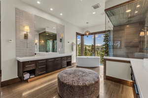 Bathroom with vanity, hardwood / wood-style flooring, and shower with separate bathtub