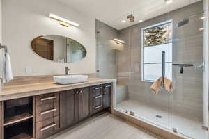 Bathroom featuring vanity and an enclosed shower