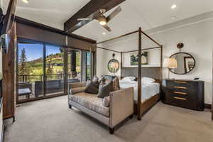 Carpeted bedroom featuring french doors, beamed ceiling, and access to outside