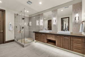 Bathroom featuring vanity and a shower with shower door