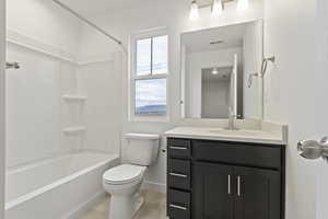 Full bathroom with vanity, tub / shower combination, and toilet