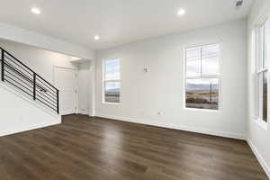 Unfurnished living room featuring hardwood / wood-style floors