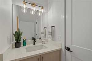 Bathroom featuring a chandelier and vanity