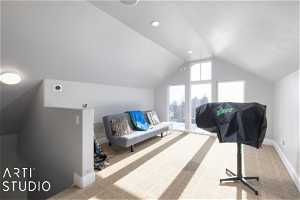 Detached Garage interior space featuring lofted ceiling and light carpet