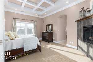 Primary bedroom with coffered ceiling, light colored carpet, ornamental molding, a tile fireplace, and beam ceiling