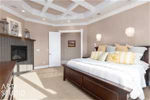 Primary bedroom with coffered ceiling, a tile fireplace, crown molding, and beam ceiling