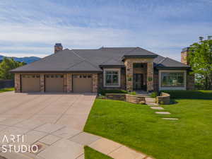 View of front of home with a garage and a front yard