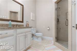 Bathroom with toilet, tile floors, large vanity, and walk in shower