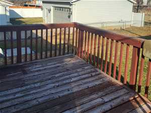Deck featuring a yard and a garage