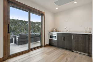 Wet bar out to expansive deck and Hot tub