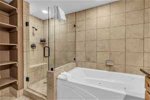 Bathroom with independent shower and bath, tile floors, and built in features