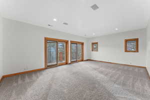 Unfurnished room featuring light carpet