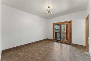 Tiled empty room with a chandelier