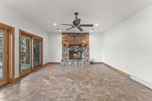 Unfurnished living room with ceiling fan, a fireplace, and light tile floors